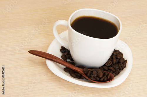 Cup of coffee on a table with a wooden spoon