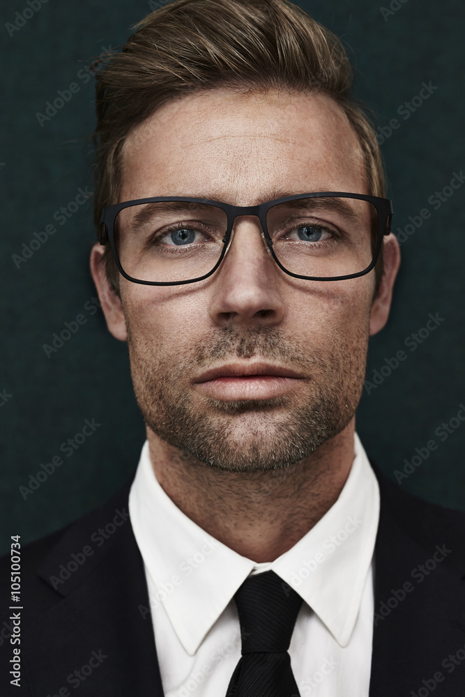 Spectacled handsome man looking at camera