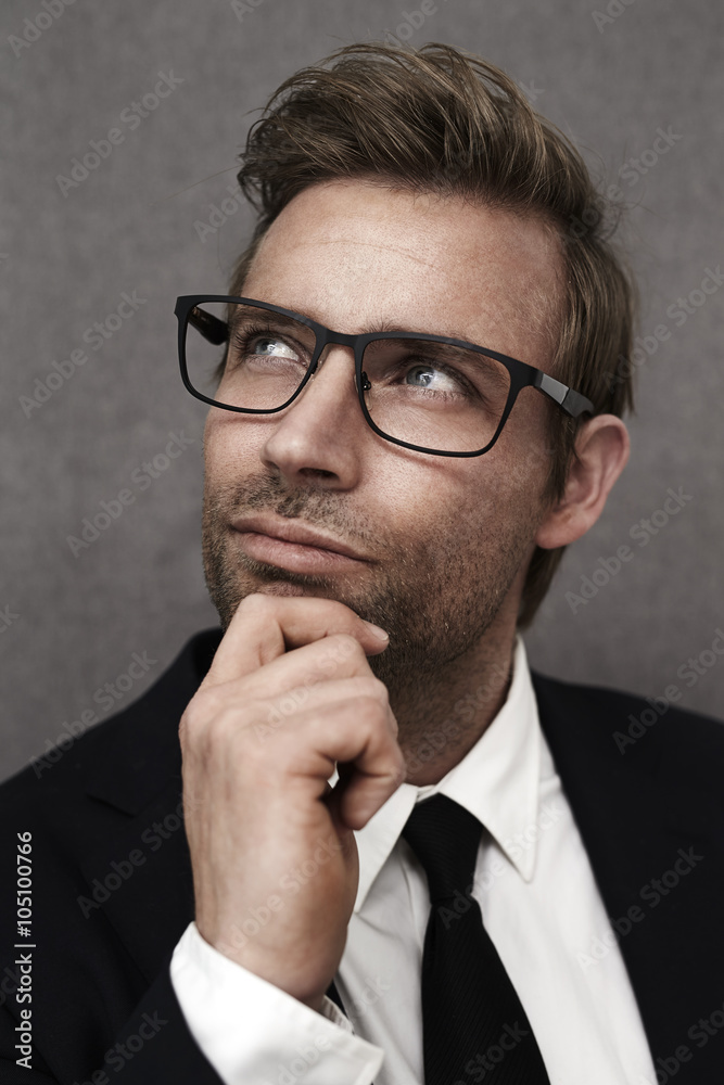 Thoughtful man in smart suit, looking up Thoughtful man in smart suit, looking up