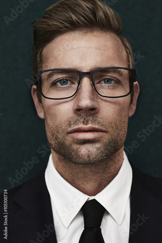 Spectacled handsome man looking at camera