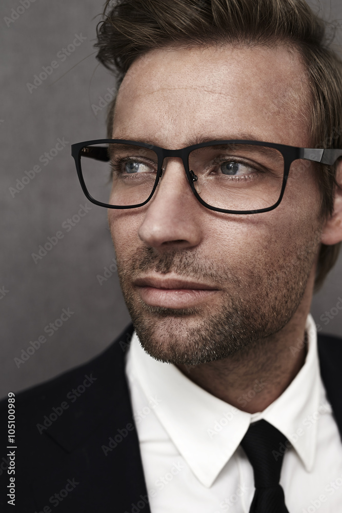 Man in suit and smart spectacles, looking away Man in suit and smart spectacles, looking away