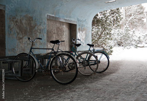 Old bicycles parking at bike rack in railway station underpass.