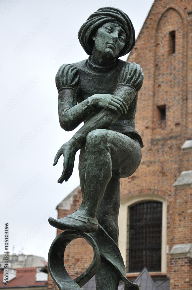 Bronze statue of a poor student near St Mary's Basilica located in Krakow, Poland