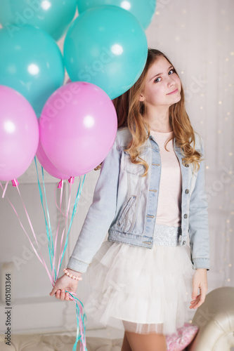 Sweet teen girl with blue and pink balloons