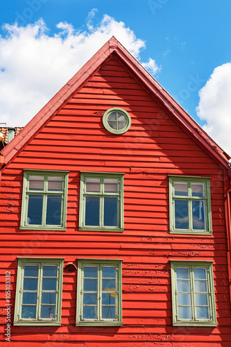 Red wooden house against the blue sky