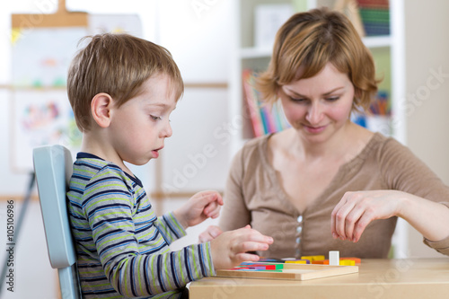 Child boy playing with educ...