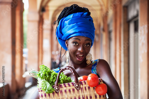 Young African woman with vegetables 