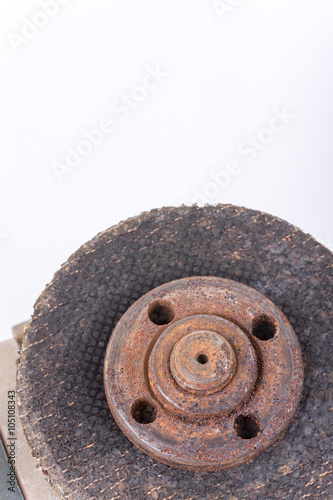 Old used rusty grinder round knife over white background