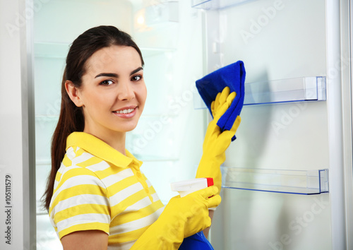 Woman washing refrigerator ...