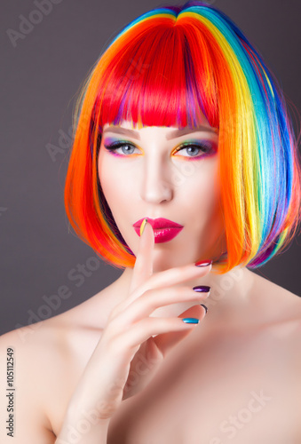 beautiful woman wearing colorful wig and showing colorful nails
