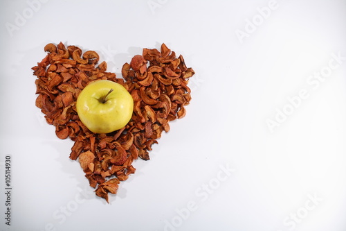 Yellow apple in the heart of dried apples