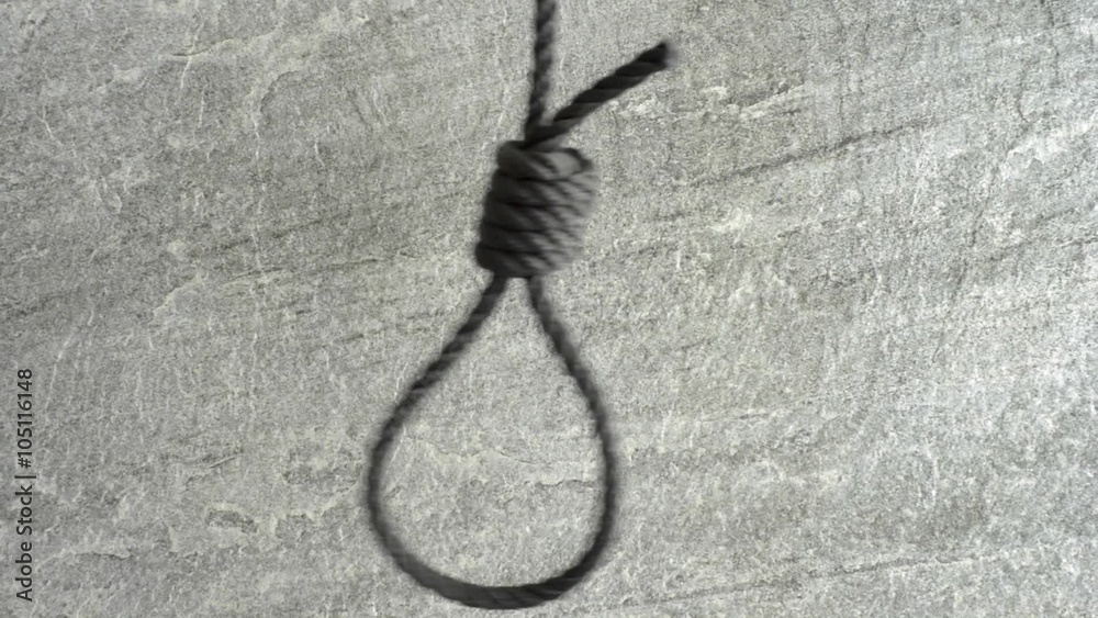Noose hanging in front of stone wall film clip. Symbol of death, capital punishment and execution.