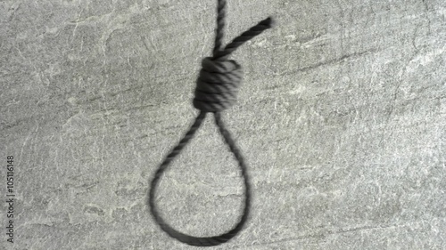 Noose hanging in front of stone wall film clip. Symbol of death, capital punishment and execution.