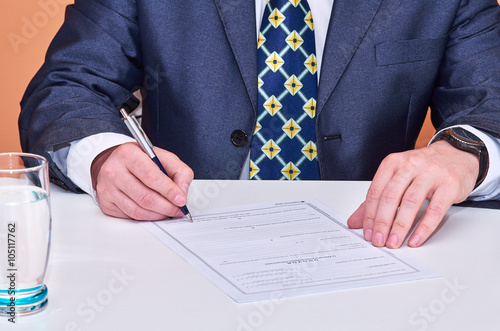 Businessman signing a contract photo