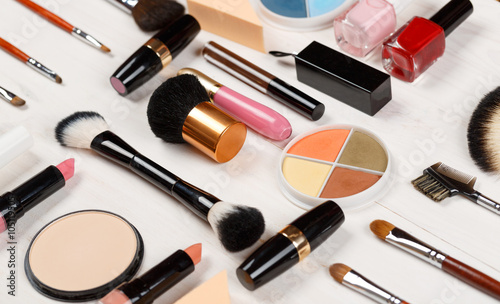 Various makeup products on wooden background