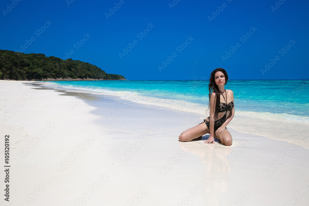 Beautiful sexy bikini model woman posing relaxing on exotic trop Beautiful sexy bikini model woman posing relaxing on exotic trop