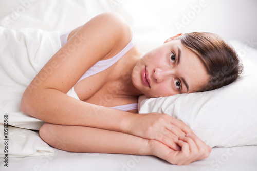 portrait of young woman in bed