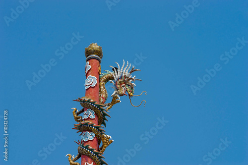 goldent dragon sculpture on blue sky photo