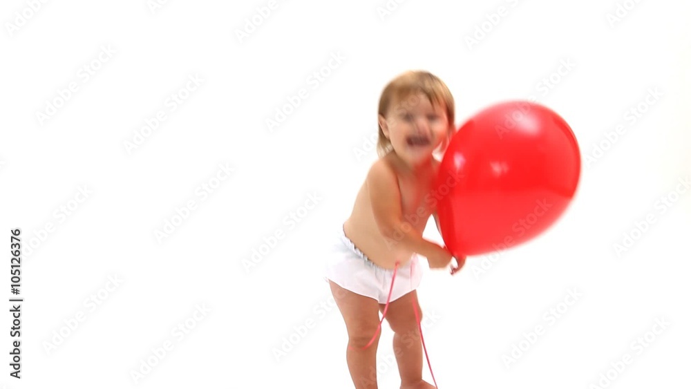 Baby playing with red balloon on white background Baby playing with red balloon on white background