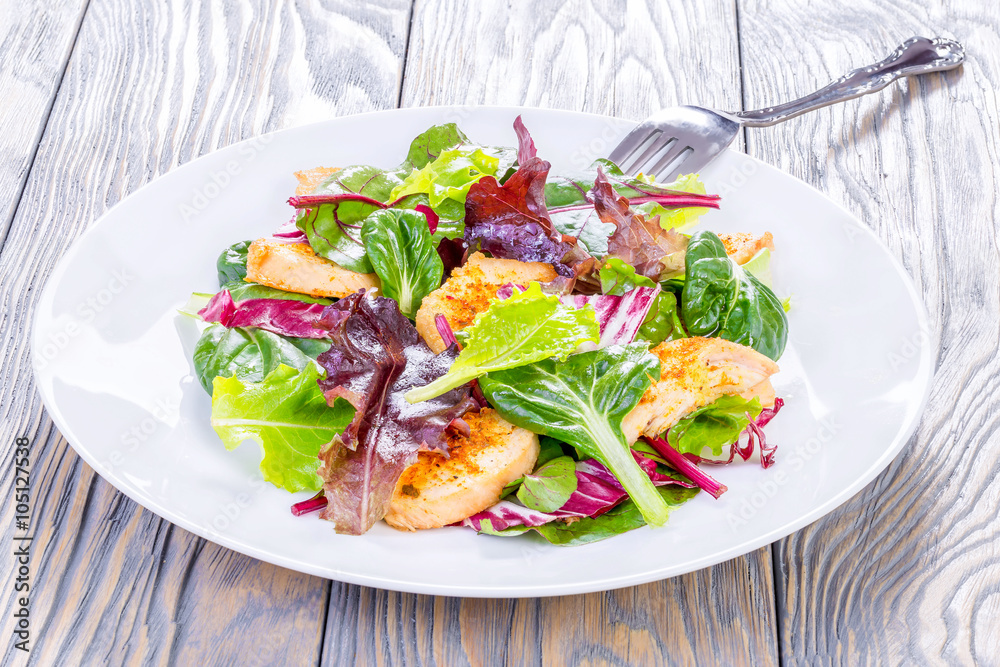 salad with chicken breast and lettuce leaves, spinach, top view salad with chicken breast and lettuce leaves, spinach, top view