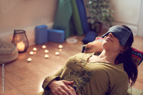 Photos Attractive mixed race woman doing restorative yoga