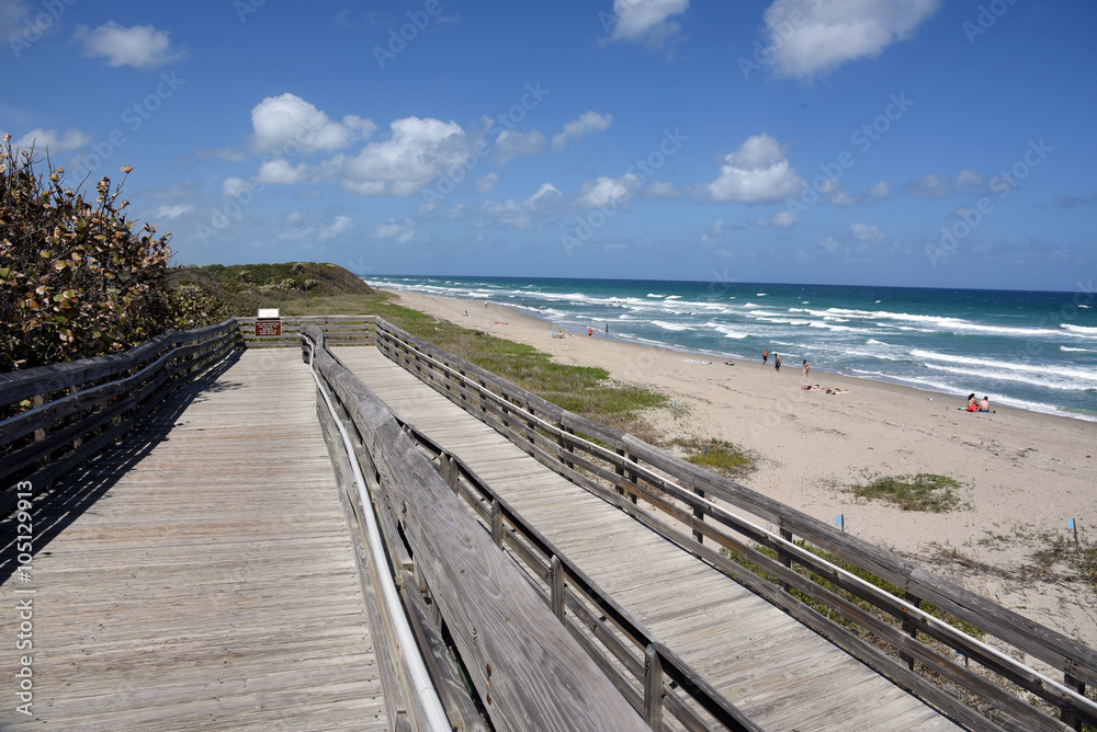 Old wooden boardwalk provides handicapped access to the beach at John D MacArthur State Park near West Palm Beach, Florida.