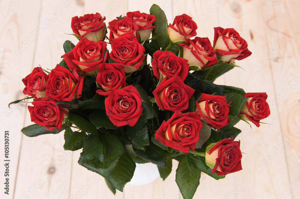 Beautiful red roses on a dark wooden table Beautiful red roses on a dark wooden table
