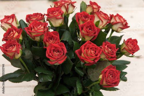 Beautiful red roses on a dark wooden table