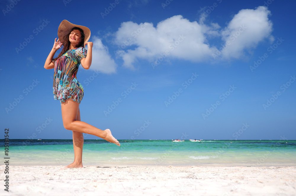 Young woman relaxing on exotic beach and enjoying the nice weath Young woman relaxing on exotic beach and enjoying the nice weath