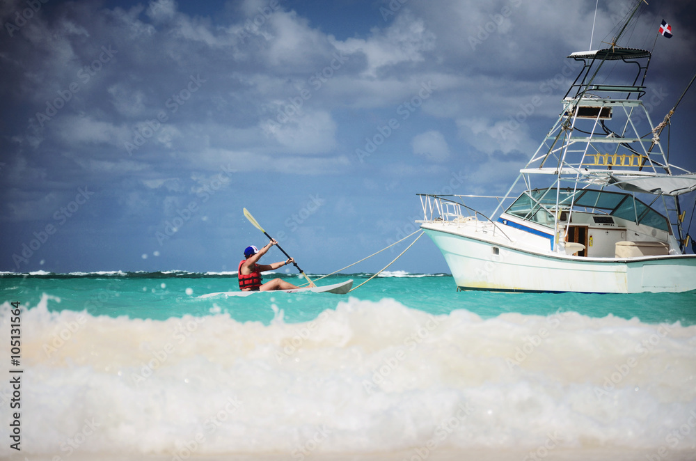 Man canoeing in the Carribean sea