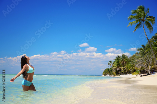 Carefree young woman enjoying clear water of the carribean sea