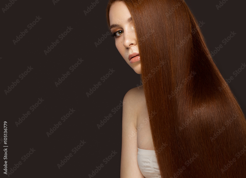 Fototapeta premium Beautiful Redheadgirl with a perfectly smooth hair and classic make-up. Beauty face. 