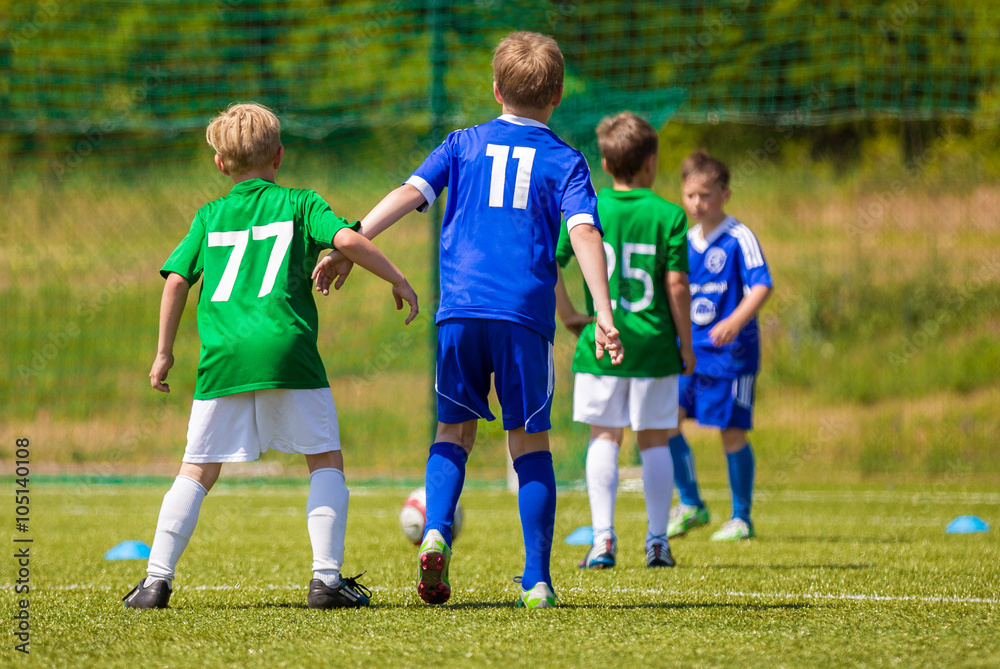 Training and football match between youth teams. Young boys play