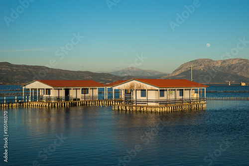 Small fishing houses on stilts on the lake Mesologgi photo