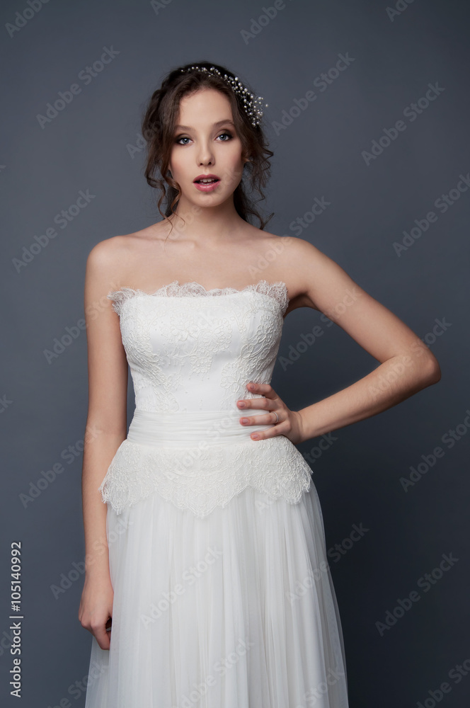 Adorable young bride with brown curly hair and pearl headpiece Adorable young bride with brown curly hair and pearl headpiece