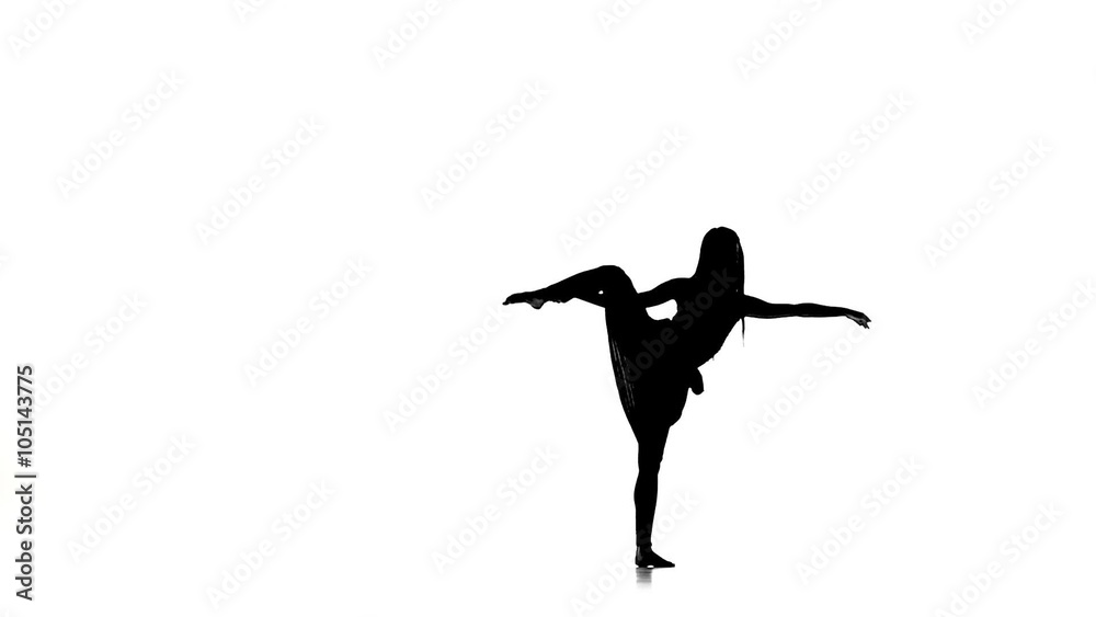 Slim woman doing a split, on white, silhouette, slow motion Slim woman doing a split, on white, silhouette, slow motion
