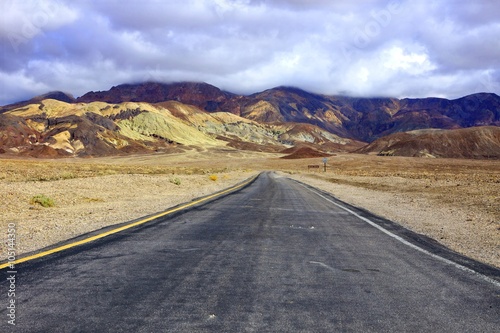 Empty road through the formations at Death Valley National Park, California