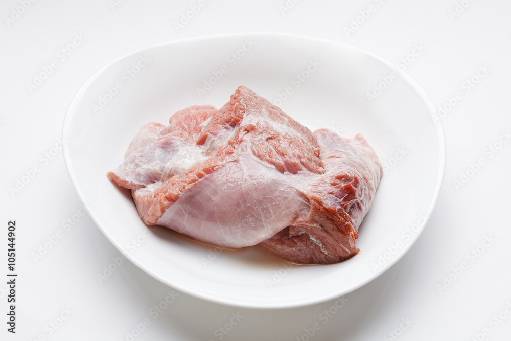 Fresh raw meat in dish, on white background Fresh raw meat in dish, on white background
