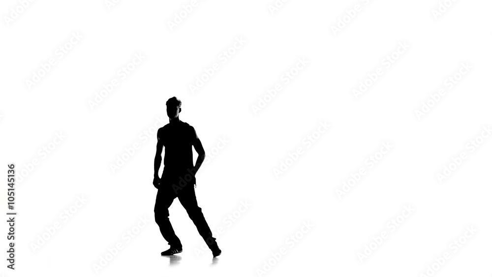Young man stands on hands dancing breakdance, white, silhouette, slow motion Young man stands on hands dancing breakdance, white, silhouette, slow motion