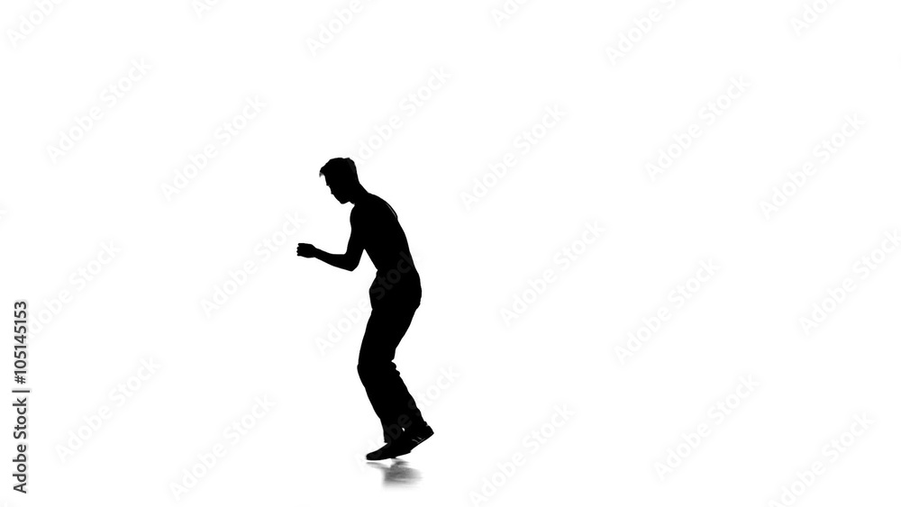 Young man dancing breakdance on one hand, white, silhouette, slow motion Young man dancing breakdance on one hand, white, silhouette, slow motion