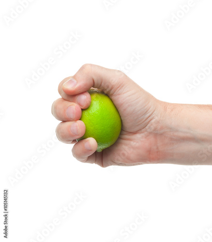 Fresh juicy tasty green lime in a human hand isolated on a white