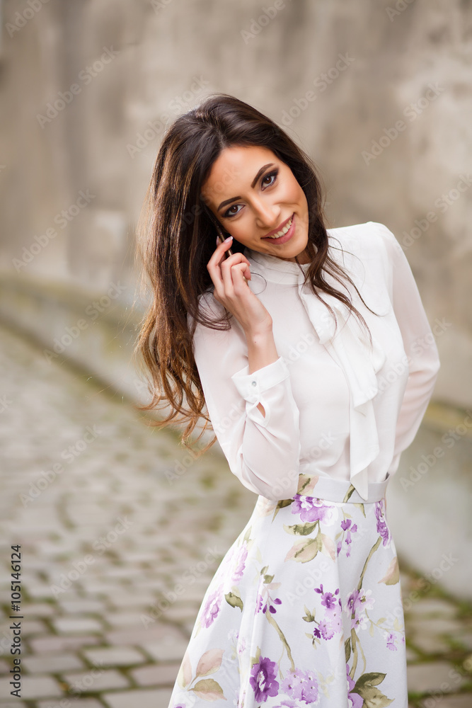 Young happy woman talking on phone