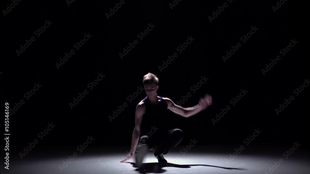 Handsome blonde breakdance style dancer dance, on black, shadow, slow motion Handsome blonde breakdance style dancer dance, on black, shadow, slow motion