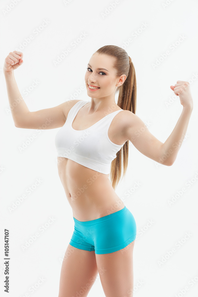 Cheerful female athlete is showing her figure Cheerful female athlete is showing her figure
