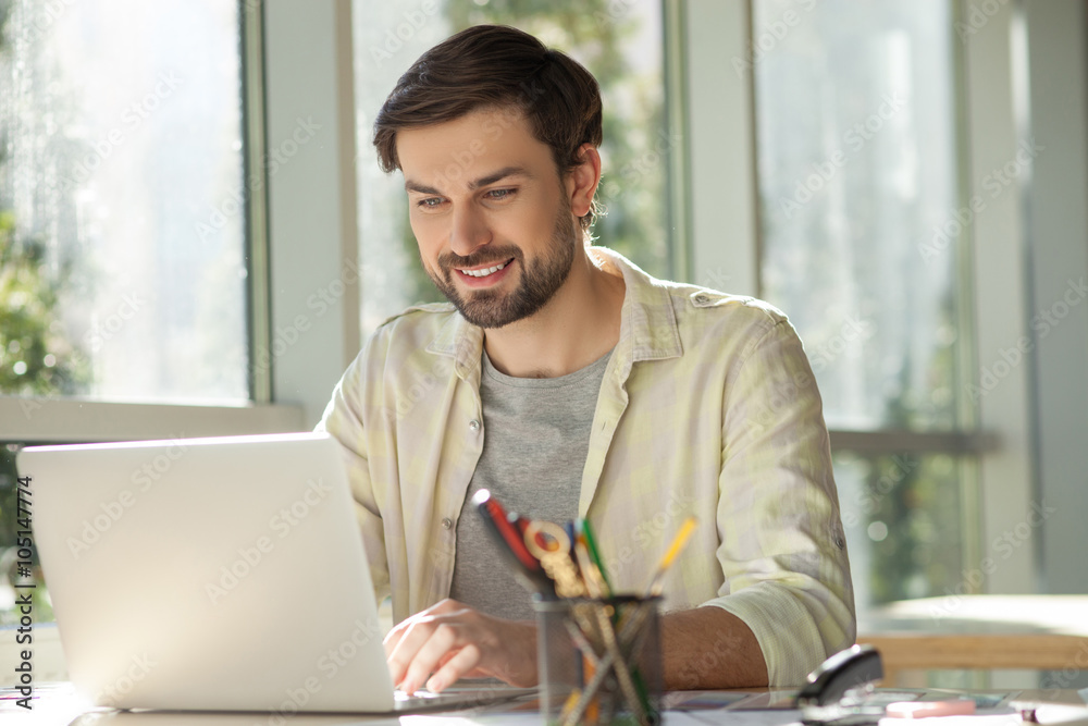 Handsome male worker us using a notebook Handsome male worker us using a notebook