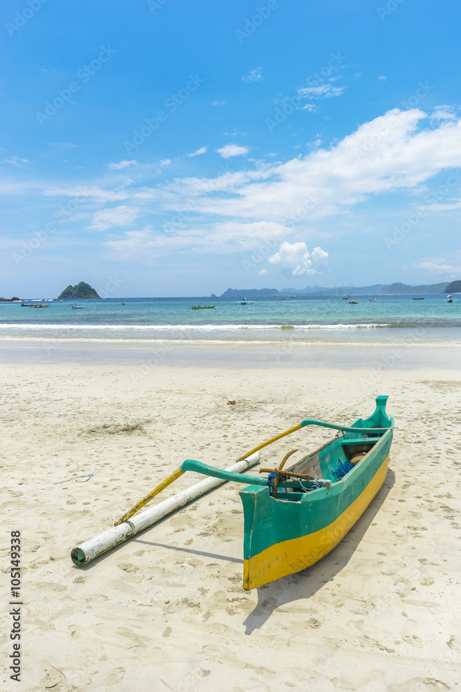 Traditional wooden boat park at sea shore with cloudy skies at South Lombok island, Indonesia Traditional wooden boat park at sea shore with cloudy skies at South Lombok island, Indonesia