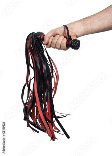 Man's hand holds a whip (flogger). Isolated on white