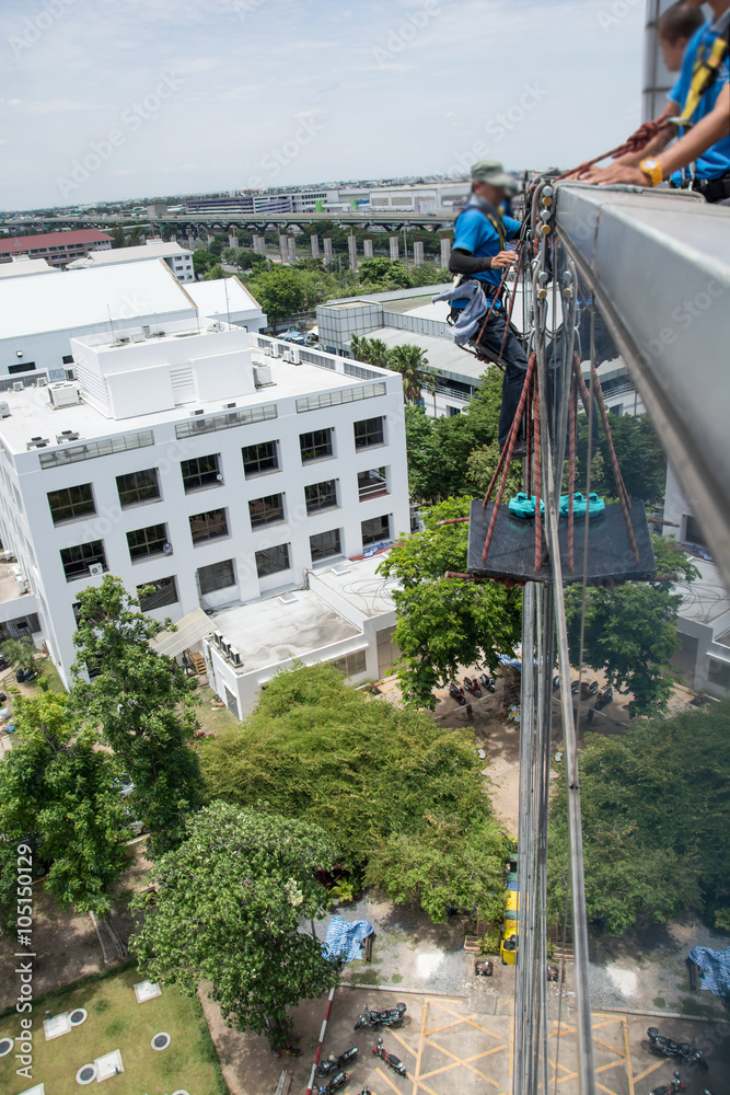  workers cleaning windows service on high rise building