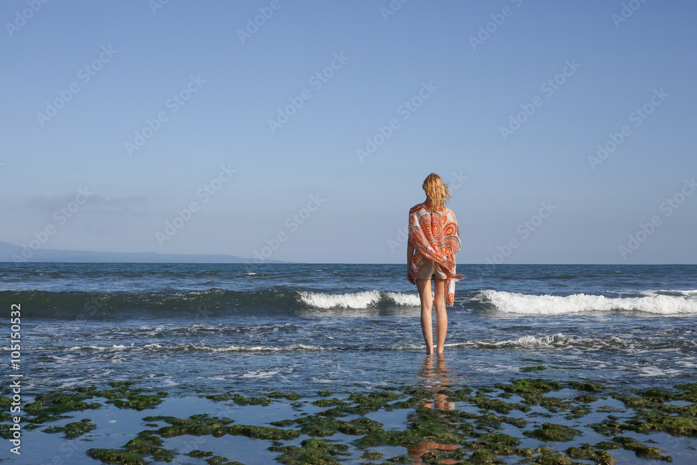 Portrait of young woman looking at the ocean