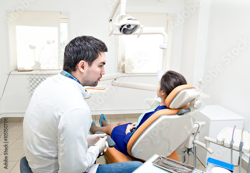 dentist in a dental clinic. The girl on reception at the dentist's chair.